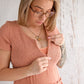 Flourish Maternity NZ - online mum and baby shop. Bella tiered dusty pink dress - pregnancy & breastfeeding flowing dress. Discrete zipper for breastfeeding access with a discretion slip underneath